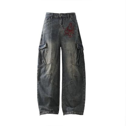 Denim cargo pants with floral embroidery on a white background